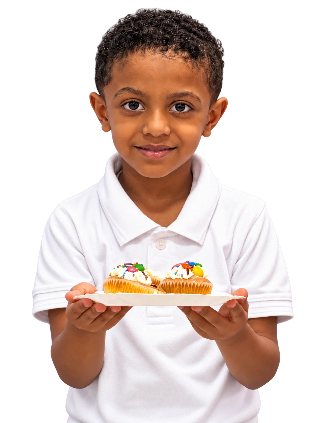 Pupil proudly holding a plate of decorated cupcakes