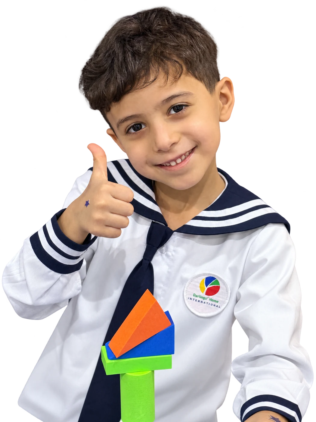 Smiling pupil giving a thumbs up beside colorful geometric blocks