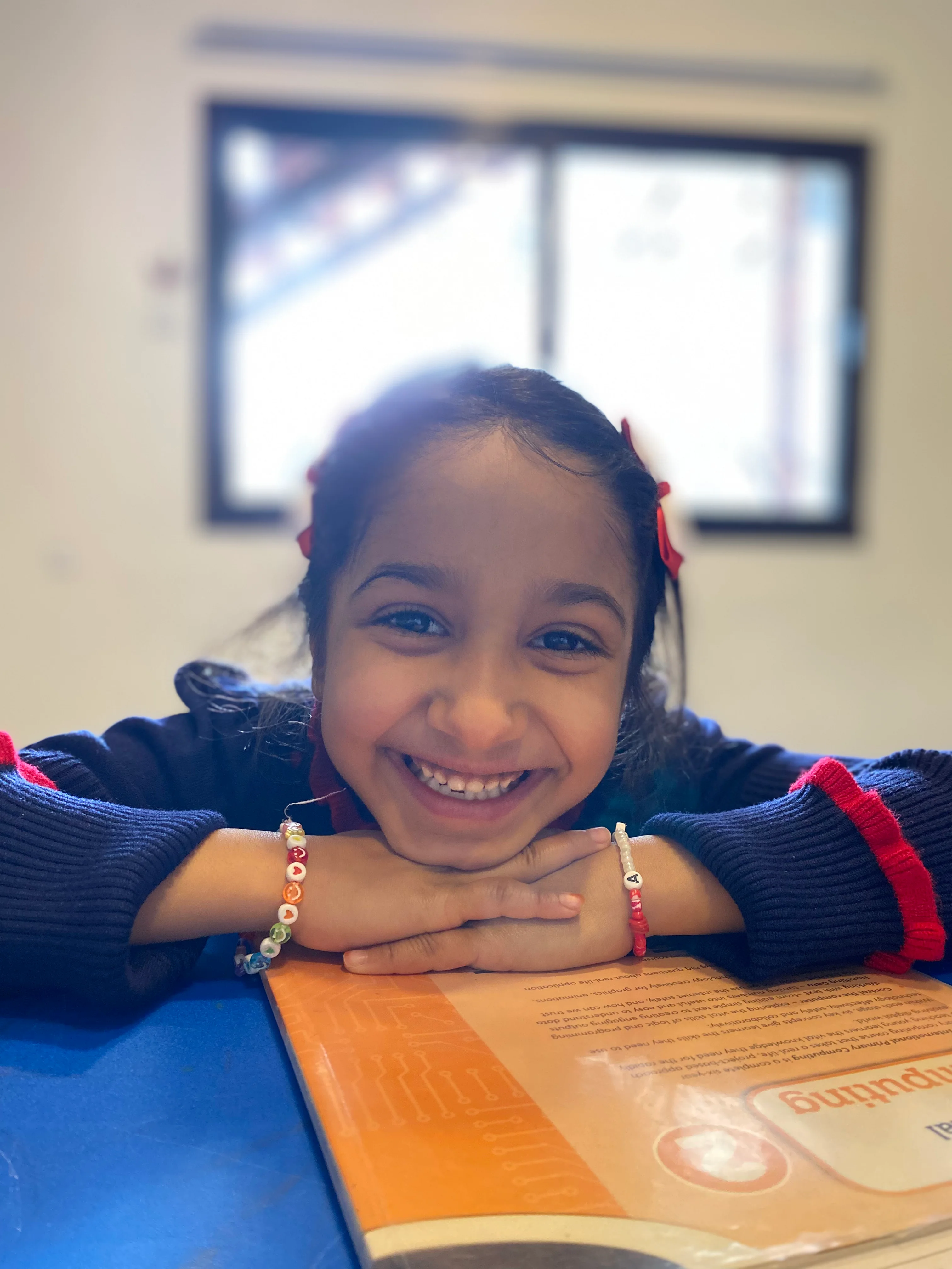 Smiling Darlings' Home student at her desk