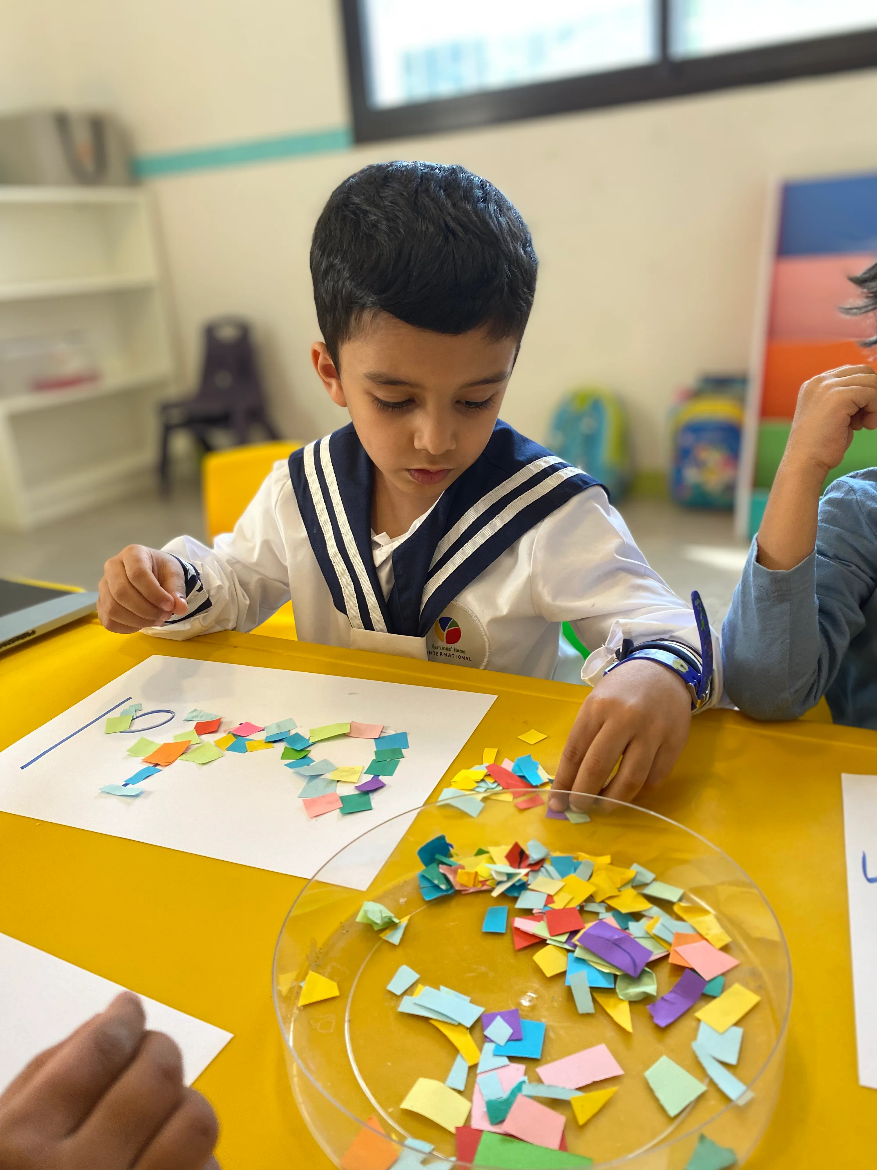Young pupil concentrating on a colourful hands-on activity